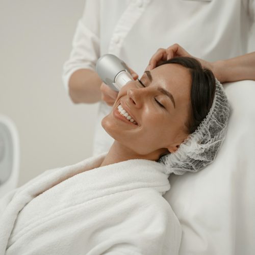 Professional cosmetologist is making cavitation rejuvenation skin treatment. Radio wave lifting